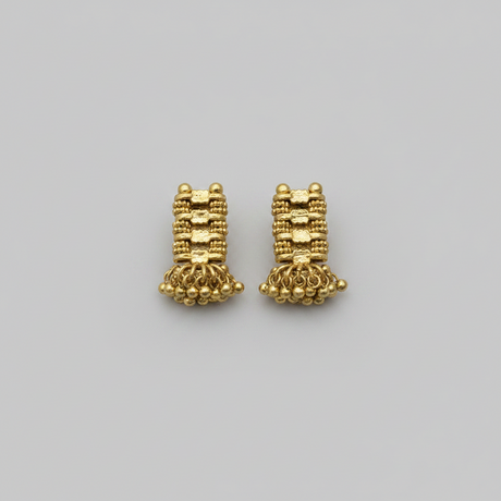 Pair of gold earrings on a gray background