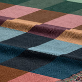Close-up of a multicolored woven fabric with a geometric pattern.