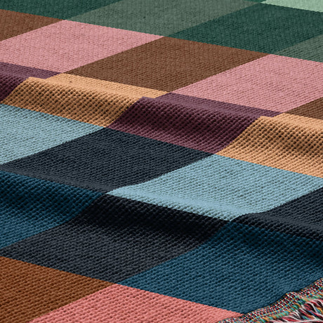 Close-up of a multicolored woven fabric with a geometric pattern.