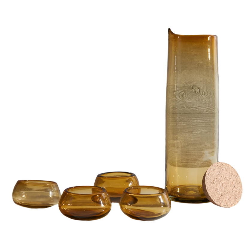Set of four amber glass bowls and a tall vase with cork base on a white background