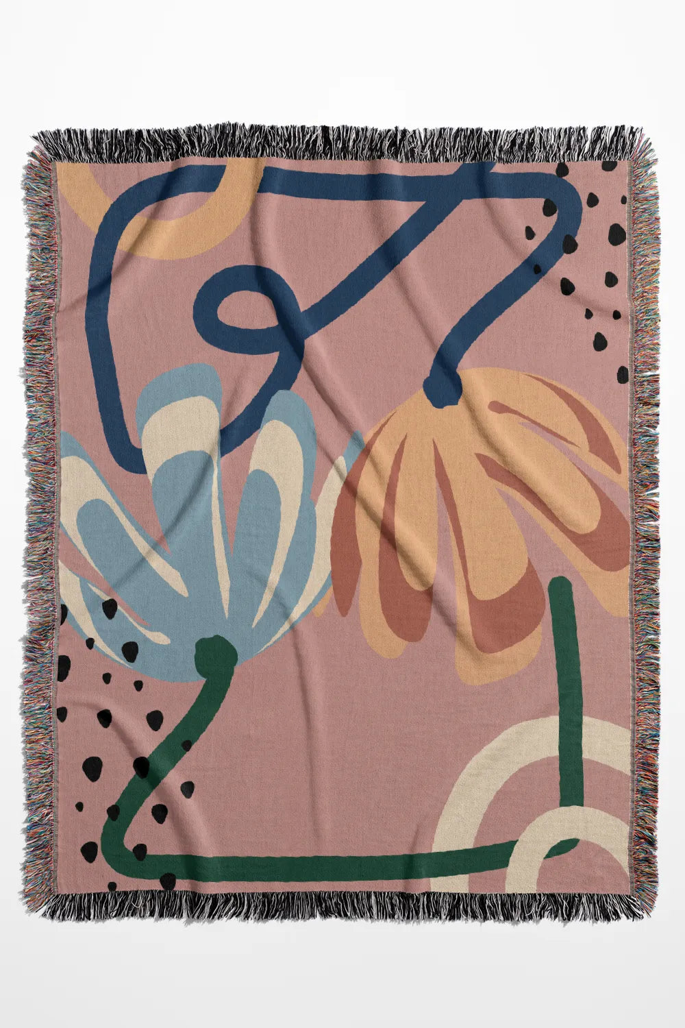 Floral-inspired pink woven cotton throw blanket featuring soft organic shapes and colorful fringe.
