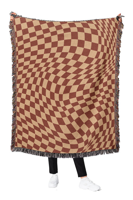 Brown and tan wavy checkered woven throw blanket with a bold geometric pattern.

