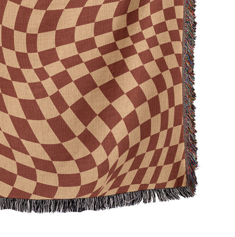 Checkered blanket with brown and beige pattern on a white background