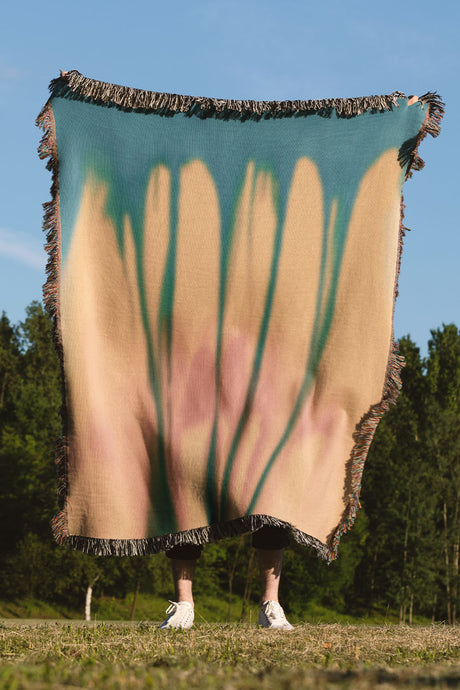 Yellow and blue gradient woven throw blanket with an abstract, organic design.
