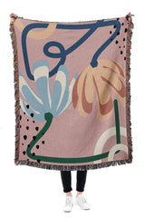 Modern pink tapestry throw blanket with botanical elements and a soft, breathable texture.
