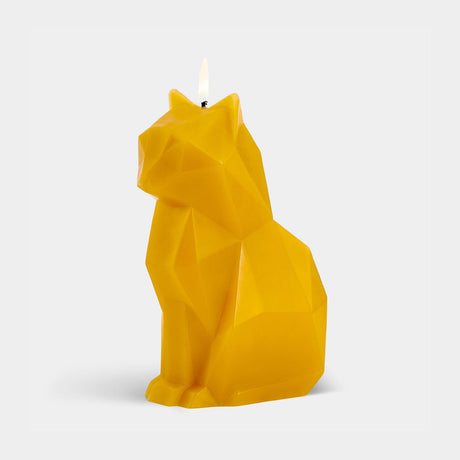 Yellow cat-shaped candle on a light gray background