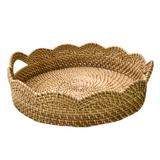 Woven basket with scalloped edge and handles on a white background