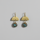 Pair of gold earrings with labradorite stones on a gray background