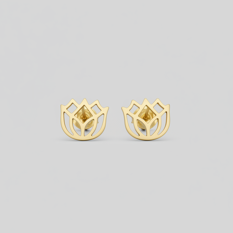 Gold earrings on a light gray background