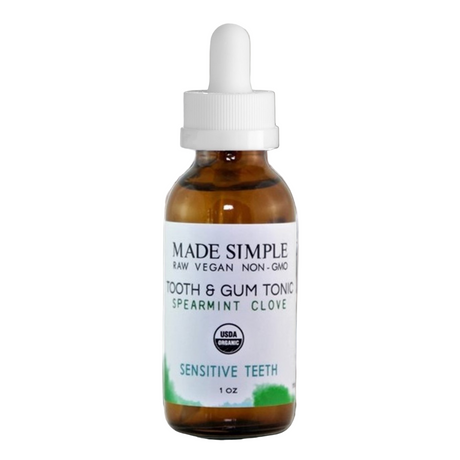Bottle of 'Made Simple' tooth and gum tonic with a dropper on a white background