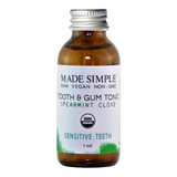 Bottle of 'Made Simple' tooth and gum tonic with a white label on a white background