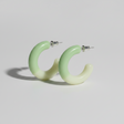 Green hoop earrings on a light gray background