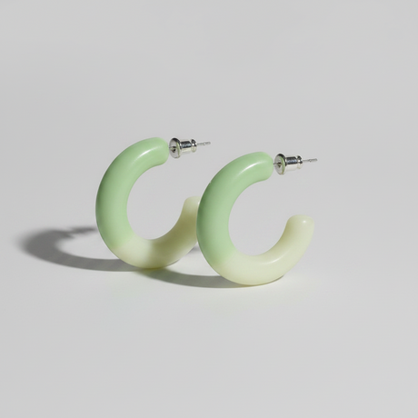 Green hoop earrings on a light gray background