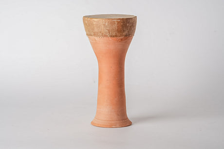 Terracotta drum with a light brown top on a white background