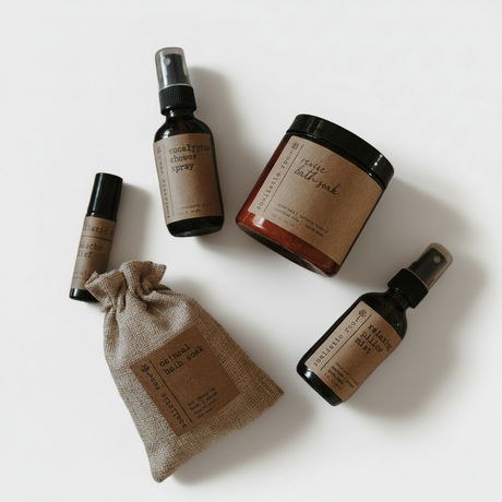 Set of natural skincare products including bottles and a pouch on a white background