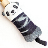 Panda-shaped skillet handle holder with a textured black and white pattern on a white background