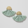 Pair of earrings with gold circular tops and light green tassels on a white background