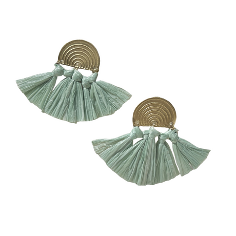 Pair of earrings with gold circular tops and light green tassels on a white background