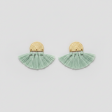 Pair of green tassel earrings with gold accents on a light gray background