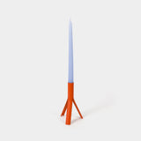 Candle with a blue top and orange base on a white background