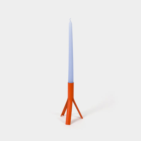 Candle with a blue top and orange base on a white background