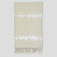 Beige towel with white fringe on a white background