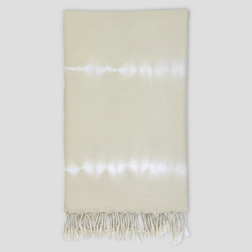 Beige towel with white fringe on a white background