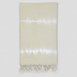 Beige towel with white fringe on a white background