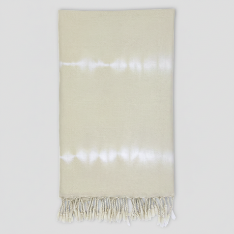 Beige towel with white fringe on a white background