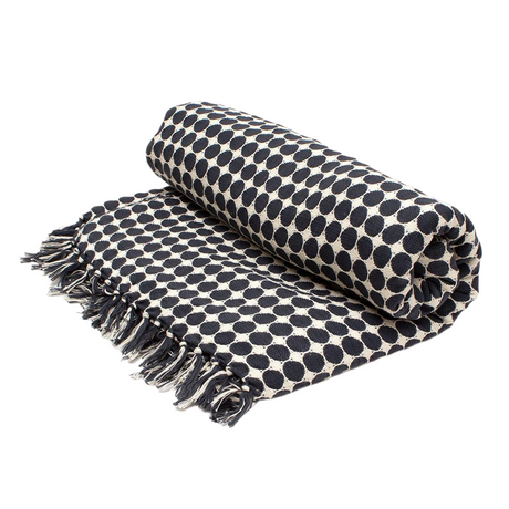 Black and white polka dot throw blanket with fringe on a white background