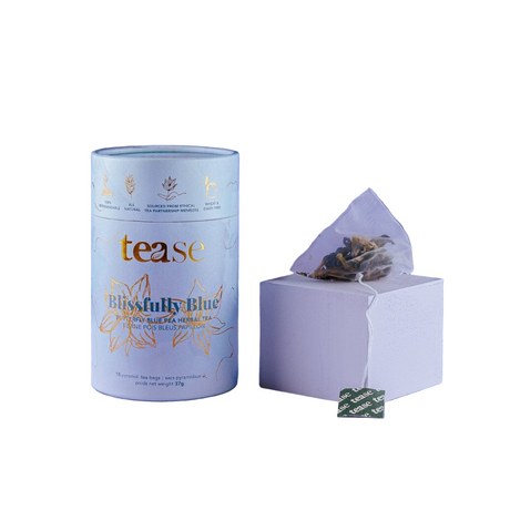 Tea packaging with 'tease' branding and 'Blissfully Blue' label on a white background.