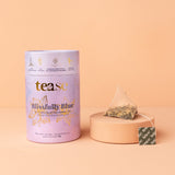 Tea packaging with a tea bag on a peach background