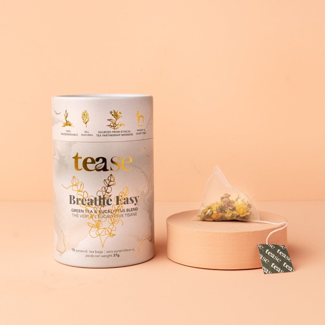 Tea canister labeled 'tease' with a tea bag on a peach background