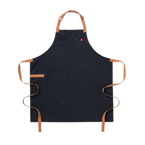 Black apron with brown straps on a white background. The Essential Apron - Midnight Blue Cotton Canvas