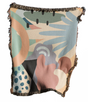 Abstract patterned blanket with fringe on a white background