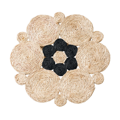 Round woven mat with black central design on a white background