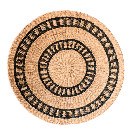 Woven placemat with black patterns on a white background