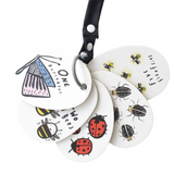 Set of white keychains with insect illustrations and a black strap on a white background