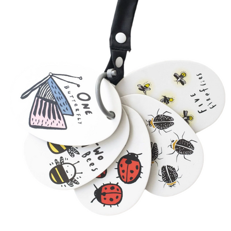 Set of white keychains with insect illustrations and a black strap on a white background