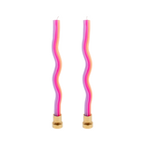 Two wavy, multicolored candles with gold bases on a white background